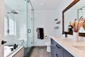 Modern bathroom renovation with a white ceramic sink and white standing shower
