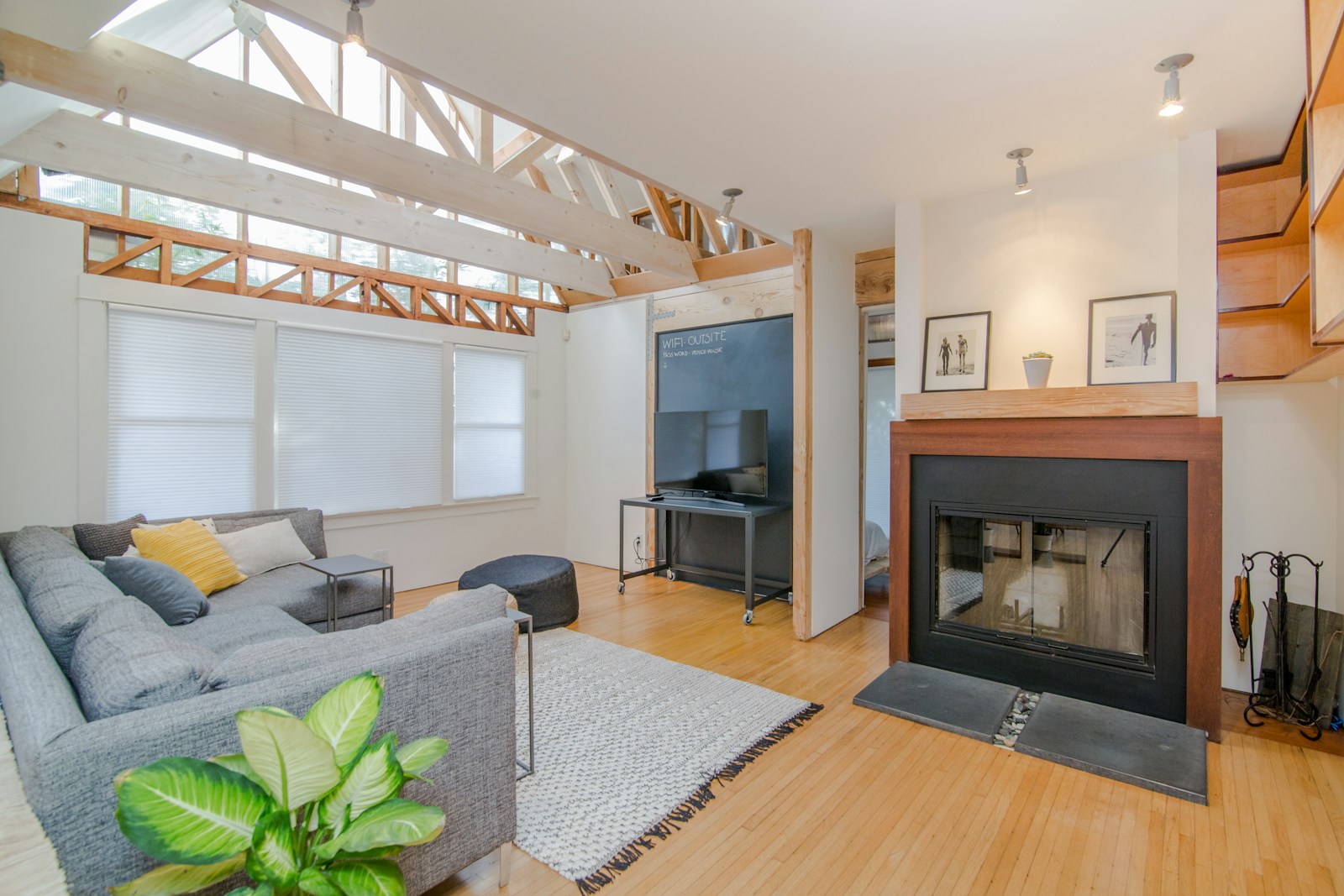 Contemporary living room with a fireplace and combination of neutral and warm wood tones