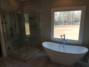 Airy Bathroom with Stone Shower and Free Standing Tub