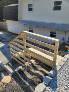 wooden walkway and stairs with safety railing